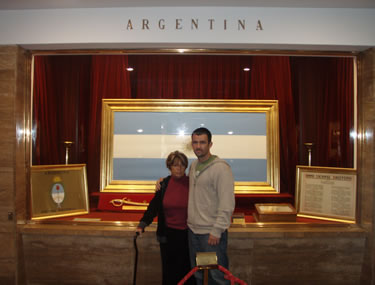 Inside the Argentinian National Flag Memorial, standing in front of the Argentinian flag with my mom